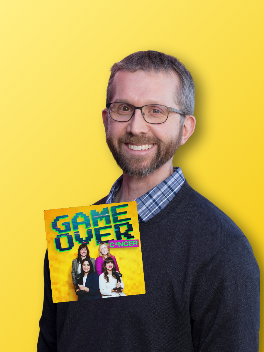 Adult pediatric cancer survivor smiling at the camera in front of a yellow backdrop. A logo of the Game Over Cancer podcast on the left-hand side.