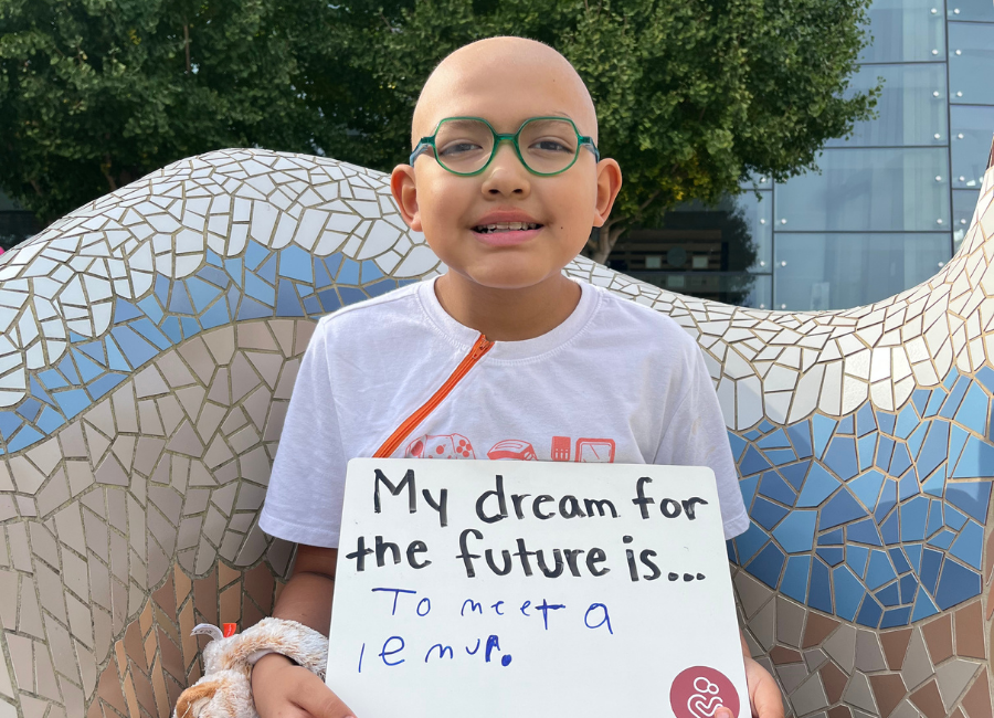 Patient holding a white board that reads "My dream for the future is to meet a lemur."
