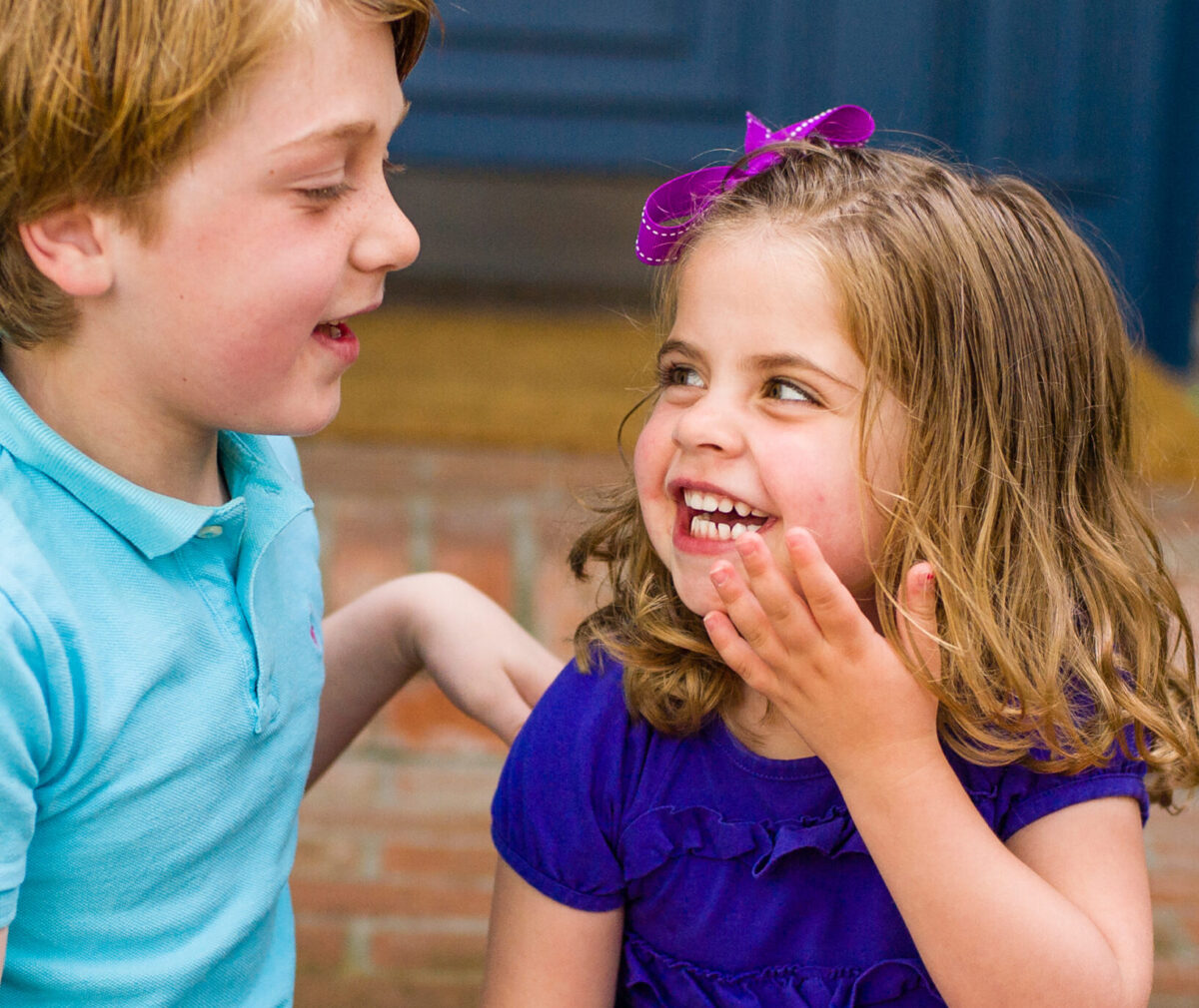 Young patient Peyton and her brother laughing
