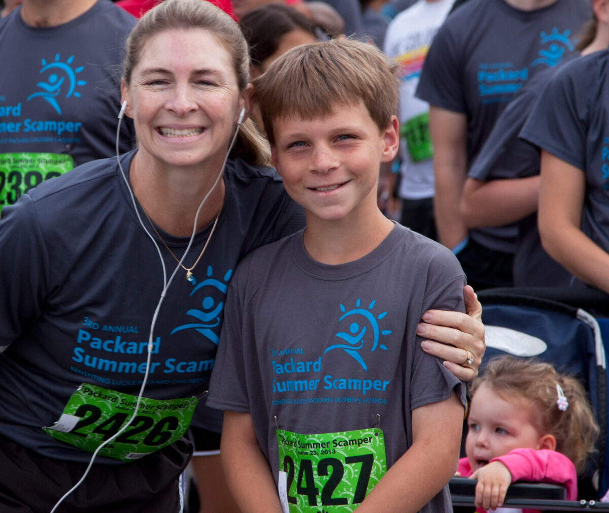 Mother and son pose together in their race t-shirts at Summer Scamper