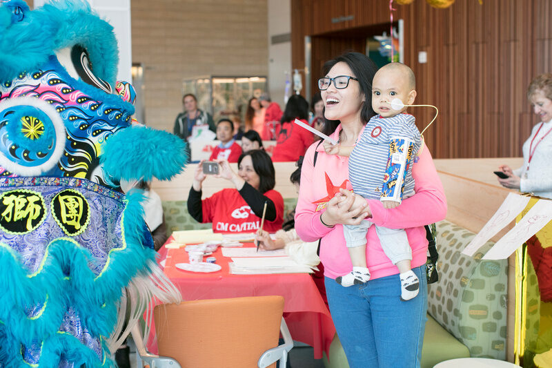 Adult holding baby at Lunar New Year.