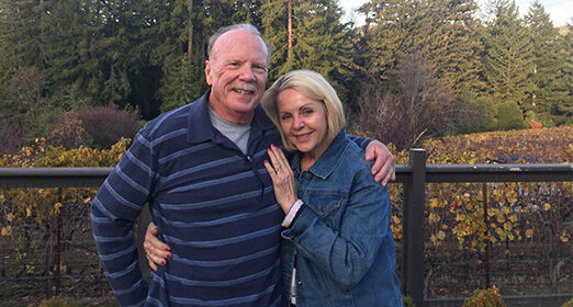 Two adults standing together, posing for a photo.