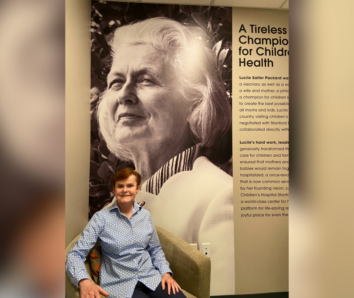 Carol Surrell posed in front of photo of Mrs. Packard.