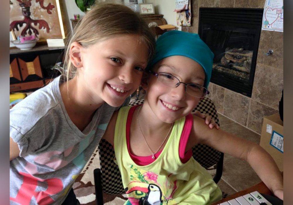 Mia and friend smiling at camera.