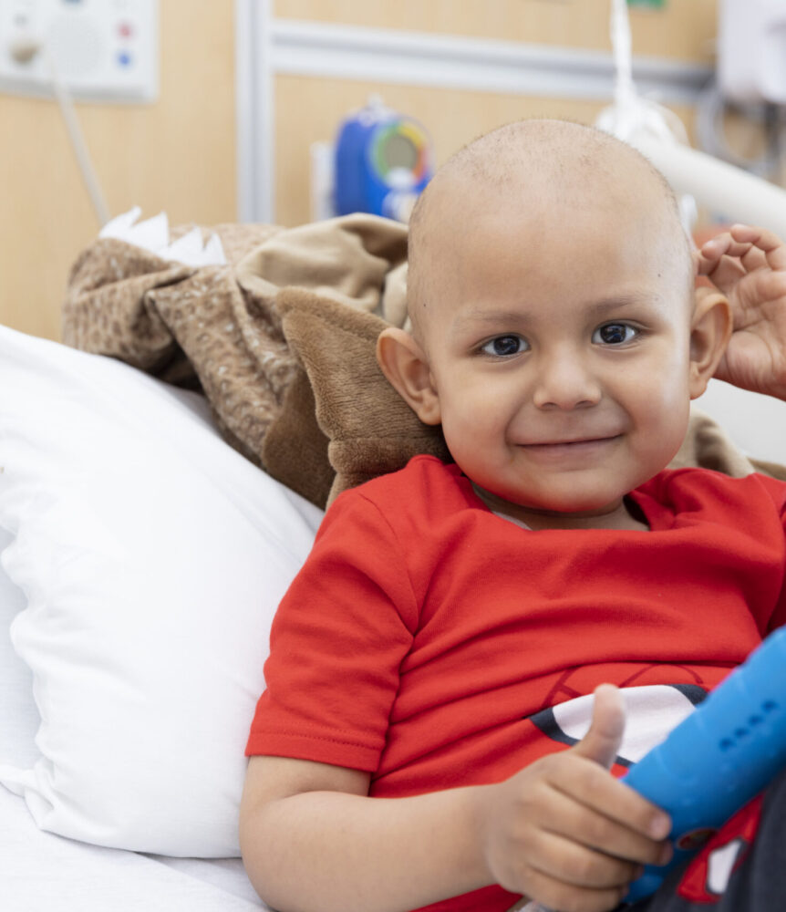 Young cancer patient smiles in bed
