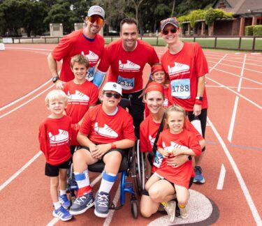 A Summer Scamper group poses on a track at Stanford University