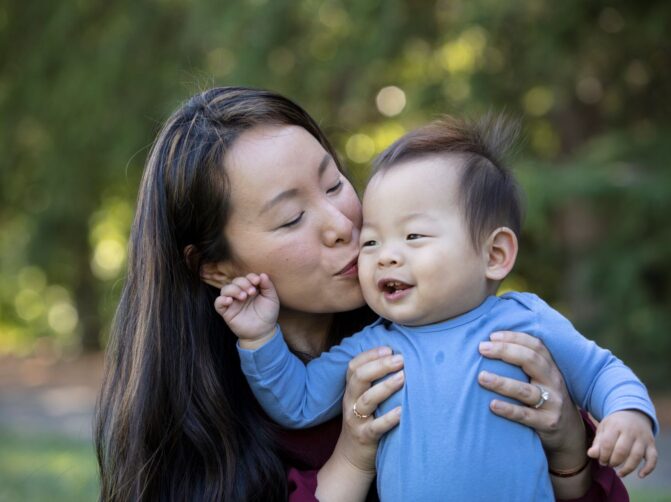 Mother kissing her young son