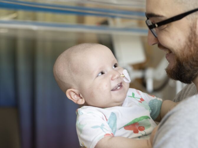 Baby smiling at father