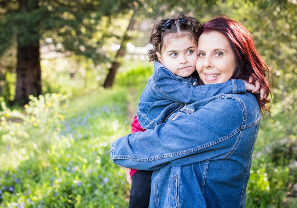 Marlee-Jo and family member pose for camera in nature setting.