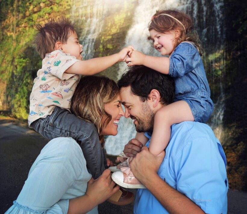 Two young patients on their parents shoulders
