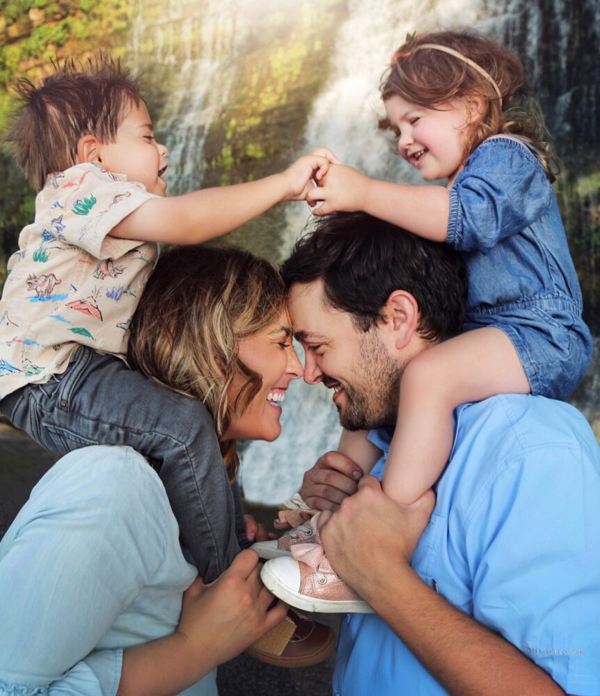 Two young patients on their parents shoulders